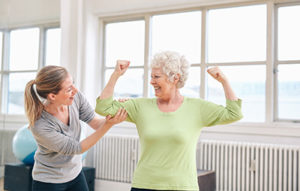 Elderly woman working out with therapist