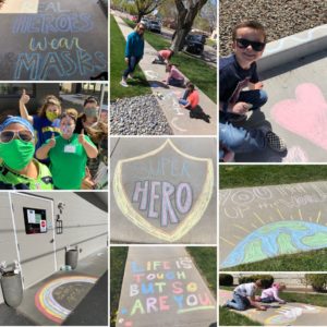 Kids wearing face masks while drawing colorful pictures with chalk on a sidewalk outside a Cascadia facility.